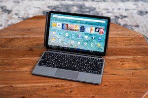 An Amazon Fire Max 11 tablet in its keyboard case on a wooden table.