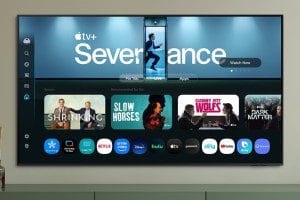 Samsung's QN80F mounted onto a wall above a media center.