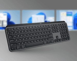 Keyboard in front of three monitors